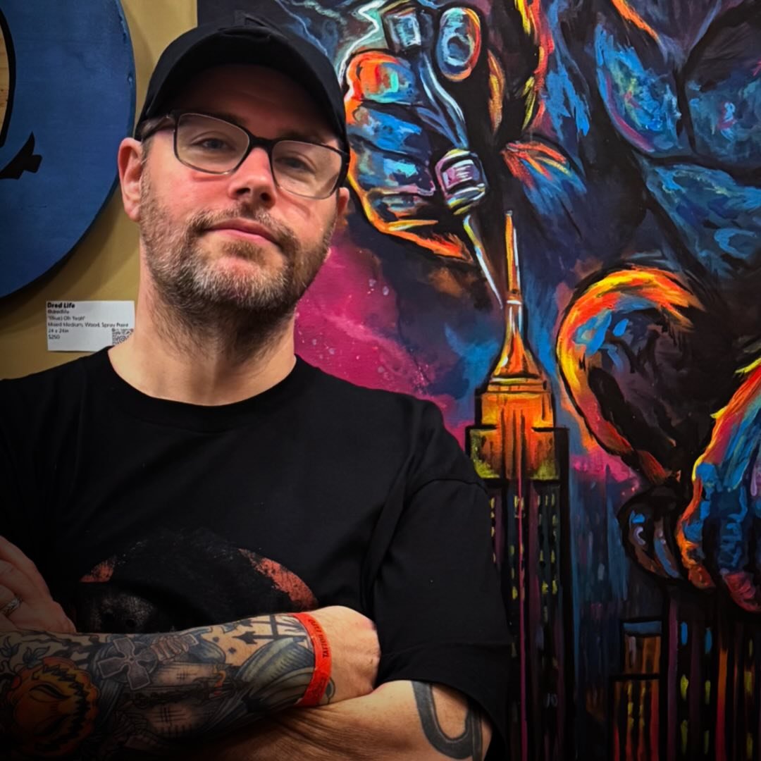Michael standing in front of colorful artwork